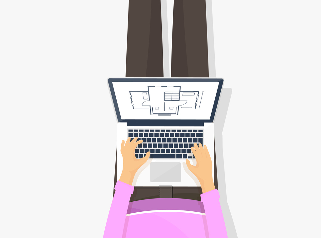 Una persona trabaja con planos arquitectónicos en una laptop, sentada con las piernas cruzadas.